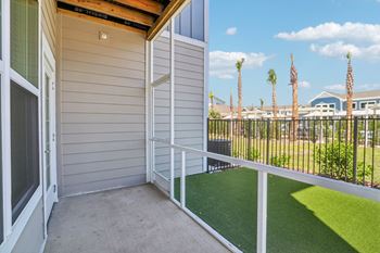 Private balcony with artificial turf and metal railing